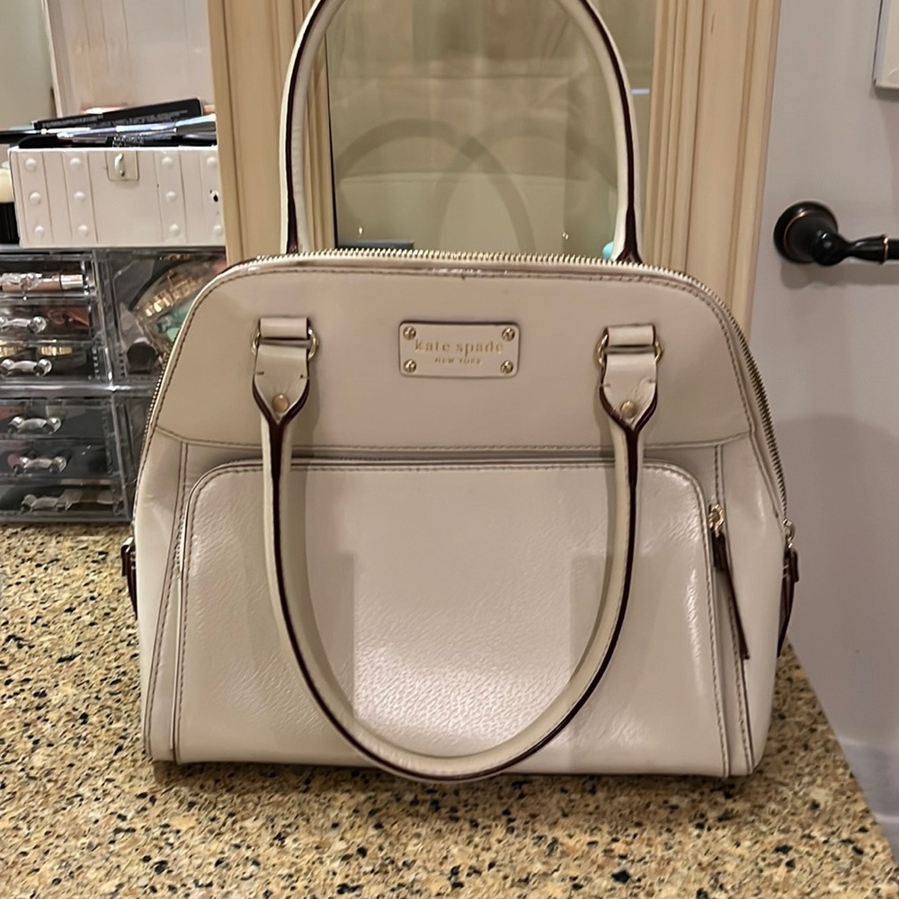 Kate Spade hand bag!!  Very loved but rarely used.. Looks like new!!